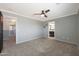 Carpeted bedroom with views into the bathroom and hallway at 29706 N 127Th Ln, Peoria, AZ 85383