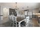 Bright dining area next to the kitchen, with island, refrigerator, and a large dining table at 29706 N 127Th Ln, Peoria, AZ 85383