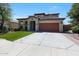 Attractive two-story home with a terracotta roof, manicured lawn, and a spacious driveway at 29706 N 127Th Ln, Peoria, AZ 85383