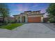 Beautiful two-story home with terracotta roof, a manicured lawn, and spacious driveway at 29706 N 127Th Ln, Peoria, AZ 85383