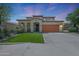 Charming two-story home featuring manicured lawn, a terracotta roof, and inviting front porch at 29706 N 127Th Ln, Peoria, AZ 85383