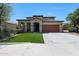 Attractive two-story home with a terracotta roof, manicured lawn, and a spacious driveway at 29706 N 127Th Ln, Peoria, AZ 85383