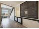 Hallway with view of the stairs and living room; decorated with a wooden sign at 29706 N 127Th Ln, Peoria, AZ 85383