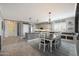 Bright, open-concept kitchen featuring an island, a dining table, and stylish decor at 29706 N 127Th Ln, Peoria, AZ 85383