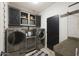 Well-equipped laundry room with washer, dryer, cabinets, and folding counter at 29706 N 127Th Ln, Peoria, AZ 85383