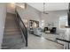 Open concept living room featuring a modern staircase, and a view into the modern kitchen at 29706 N 127Th Ln, Peoria, AZ 85383