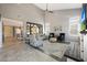 Bright living room with an open floorplan and modern fireplace, connecting to the kitchen at 29706 N 127Th Ln, Peoria, AZ 85383