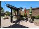A well-equipped outdoor kitchen with a grill, countertop space, and a pergola for shade and beauty at 29706 N 127Th Ln, Peoria, AZ 85383