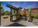 Outdoor kitchen with a grill, countertop space, and a pergola with bar in the backyard at 29706 N 127Th Ln, Peoria, AZ 85383