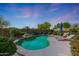 Backyard oasis with a sparkling pool, lush landscaping, and lounge chairs for ultimate relaxation and enjoyment at 29706 N 127Th Ln, Peoria, AZ 85383