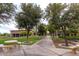 Outdoor walkway with park benches lined with trees and grassy areas, with view of community building at 29706 N 127Th Ln, Peoria, AZ 85383