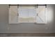 A close up of a window, featuring the open white barn door shutters at 29706 N 127Th Ln, Peoria, AZ 85383