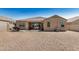 Rear elevation of home with patio, desert landscaping, and sliding glass doors at 30208 W Fairmount Ave, Buckeye, AZ 85396