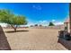 Expansive backyard with low-maintenance desert landscaping and block fence at 30208 W Fairmount Ave, Buckeye, AZ 85396