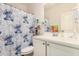 Bathroom featuring a playful cartoon-themed shower curtain and a clean, white vanity at 30208 W Fairmount Ave, Buckeye, AZ 85396