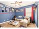 Sports-themed bedroom with a comfortable seating area, decor, and a ceiling fan at 30208 W Fairmount Ave, Buckeye, AZ 85396