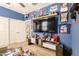 Sports themed bedroom features a large TV, fan, and convenient access to the bathroom at 30208 W Fairmount Ave, Buckeye, AZ 85396