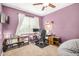 Bedroom features desk, chair, shelves, and window providing natural light, with purple walls at 30208 W Fairmount Ave, Buckeye, AZ 85396