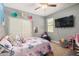 Cozy bedroom with playful decor, ceiling fan, and carpeted floors creating a warm atmosphere at 30208 W Fairmount Ave, Buckeye, AZ 85396