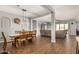 Open-concept dining room with wood floors, stylish lighting, and easy access to the living area at 30208 W Fairmount Ave, Buckeye, AZ 85396