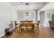 Dining room featuring a rustic table, chandelier, and wood-look flooring at 30208 W Fairmount Ave, Buckeye, AZ 85396