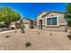 Single-story home with desert landscaping, a two-car garage, and an extended driveway at 30208 W Fairmount Ave, Buckeye, AZ 85396