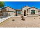 Charming single-story home featuring desert landscaping, a two-car garage, and a welcoming front entryway at 30208 W Fairmount Ave, Buckeye, AZ 85396