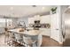 Well-lit kitchen with a large island, seating, stainless appliances, and adjacent dining area at 30208 W Fairmount Ave, Buckeye, AZ 85396