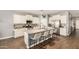 Bright kitchen featuring a large island with bar stool seating, modern appliances, and wood flooring at 30208 W Fairmount Ave, Buckeye, AZ 85396