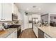 Bright kitchen featuring granite countertops, stainless steel appliances, and wood-look flooring at 30208 W Fairmount Ave, Buckeye, AZ 85396