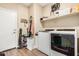 Convenient laundry room features tile floors, washer, dryer, and shelving for storage at 30208 W Fairmount Ave, Buckeye, AZ 85396