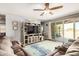 Spacious living room featuring a ceiling fan, large television, and sliding glass doors at 30208 W Fairmount Ave, Buckeye, AZ 85396
