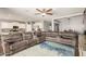 Open living space with a sectional sofa connecting the living room and the kitchen at 30208 W Fairmount Ave, Buckeye, AZ 85396
