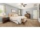 Comfortable main bedroom showcasing a plush bed, dresser, and ceiling fan at 30208 W Fairmount Ave, Buckeye, AZ 85396