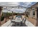 Backyard patio with metal gazebo over table and chairs; perfect for outdoor entertaining near the inground pool at 30213 W Fairmount Ave, Buckeye, AZ 85396