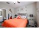 Bedroom features a ceiling fan, large window, and a plush bed with decorative lamps at 30213 W Fairmount Ave, Buckeye, AZ 85396
