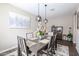 This dining room features stylish decor, a modern light fixture, and a patterned rug at 30213 W Fairmount Ave, Buckeye, AZ 85396