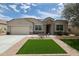 Charming single-story home with stone accents, manicured landscaping, and a well-maintained lawn at 30213 W Fairmount Ave, Buckeye, AZ 85396