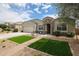 Single-story home showcases a well-manicured lawn, brick-lined walkway, and covered porch at 30213 W Fairmount Ave, Buckeye, AZ 85396