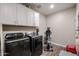 Laundry room with washer, dryer, and cabinets at 30213 W Fairmount Ave, Buckeye, AZ 85396