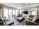 Spacious living room with comfortable seating, sliding glass doors, and a ceiling fan at 30213 W Fairmount Ave, Buckeye, AZ 85396