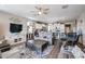 Open concept living space with comfortable seating flowing into modern kitchen with island at 30213 W Fairmount Ave, Buckeye, AZ 85396