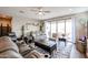 Spacious living room with comfortable seating, sliding glass doors, and a ceiling fan at 30213 W Fairmount Ave, Buckeye, AZ 85396
