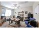 A dedicated home office features a ceiling fan, a large desk and a comfortable chair at 30213 W Fairmount Ave, Buckeye, AZ 85396