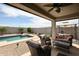 Outdoor patio with comfortable seating around backyard pool offering relaxation at 30213 W Fairmount Ave, Buckeye, AZ 85396