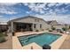 Backyard featuring a private pool, covered patio, and outdoor dining area, perfect for relaxing and entertaining at 30213 W Fairmount Ave, Buckeye, AZ 85396