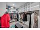 Large walk-in closet with custom shelves, hanging rods, and storage for all your wardrobe at 30213 W Fairmount Ave, Buckeye, AZ 85396