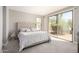 Bedroom with a plush bed, desert views, and ample natural light at 32627 N 70Th St, Scottsdale, AZ 85266