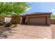 Tan home with a tile roof, gravel landscaping, and a green desert tree in front at 32627 N 70Th St, Scottsdale, AZ 85266