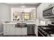 Kitchen features stainless steel appliances and pass through view to the Living Room at 32627 N 70Th St, Scottsdale, AZ 85266